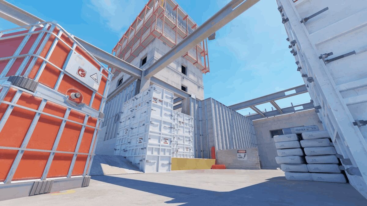 A building with orange and white crates on the CS2 map Vertigo